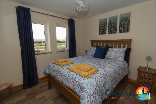 een slaapkamer met een bed met twee handdoeken erop bij Burrian - OR00247F, Lyermira - OR00249F, & Kirkquoy - OR00248F, Harray, Orkney in Orkney