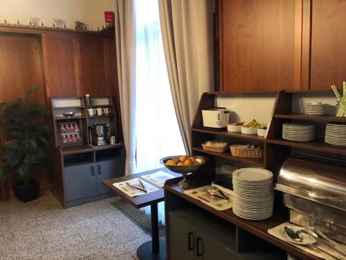 a kitchen with a counter with plates and dishes at Hotel Rheinischer Hof Bad Soden in Bad Soden am Taunus