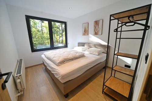 a bedroom with a bunk bed and a ladder at Chalet des Bois in Durbuy
