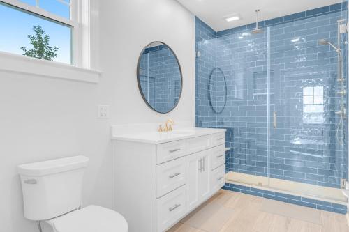 a bathroom with a toilet and a shower with blue tiles at Town of Bethany Beach --- 220 4th Street in Bethany Beach