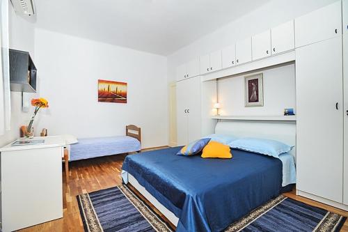 a bedroom with a large blue bed and a sink at Apartment in Poljana with sea view, terrace, air conditioning, WiFi 3617-1 in Poljana