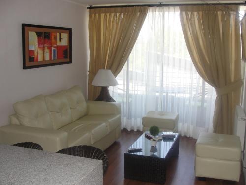 a living room with a couch and a table at Apartment Las Heras in Santiago