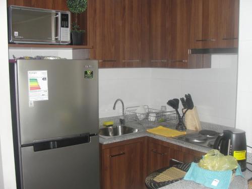 a kitchen with a stainless steel refrigerator and a sink at Apartment Las Heras in Santiago