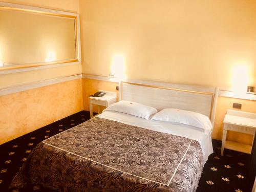 a bedroom with a large bed with two pillows at MOTEL Malpensa INN & Hotel-Airport in Tornavento