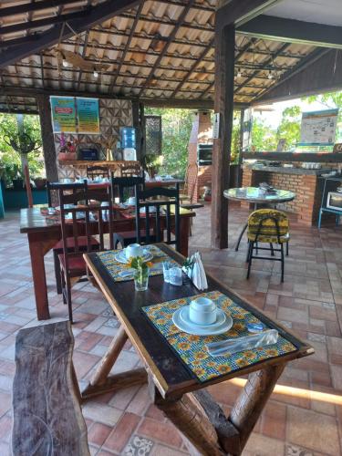 a table with a plate on it on a patio at Pousada Cachoeiras do Cipó in Serra do Cipo
