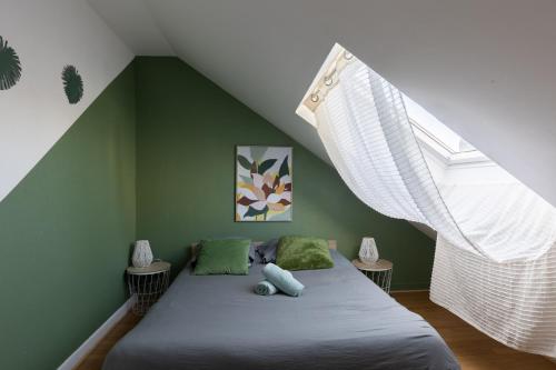 a small bedroom with a bed with a window at L'appart K-shmire- Cosy et spacieux, 4 pers in Le Mans