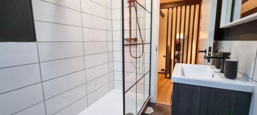a bathroom with a sink and a glass shower at Super Stylish Apartment in Urmston Flat 3 in Urmston