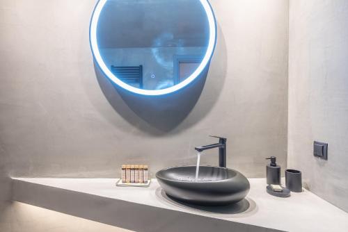 a bathroom with a black sink and a mirror at Snowglory Boutique Hotel in Arachova