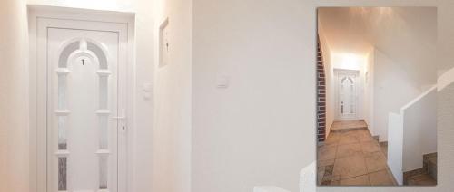 a hallway with white walls and a white door at Apartment in Novalja with sea view, terrace, air conditioning, WiFi 3565-1 in Novalja