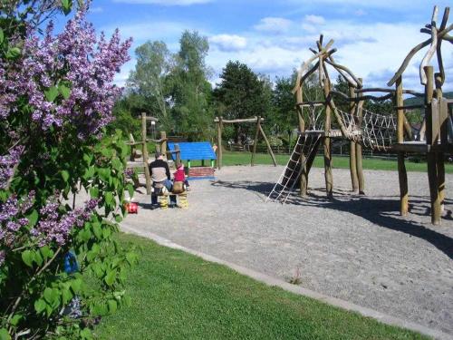 a playground in a park with people playing on it at Feriendorf Öfingen - Urlaub im Schwarzwald in Bad Dürrheim