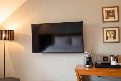 a flat screen tv hanging on a wall at Radisson Hotel Tamboho Waterfront Antananarivo in Antananarivo
