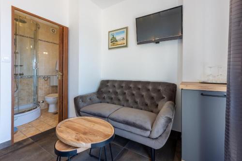 a living room with a couch and a table at Apartments Domino R in Dramalj