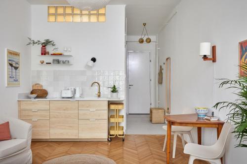 a kitchen and dining room with a table and a kitchen at Asbóth 225 COZY CENTER APARTMENT in Budapest