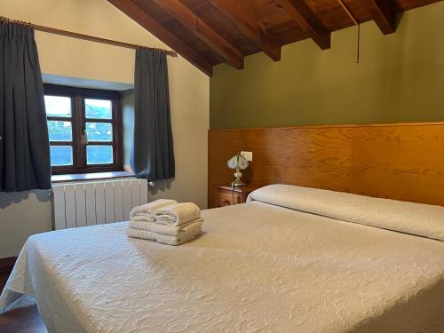 a bedroom with two beds with towels on them at Complejo la Regalina in Cadavedo