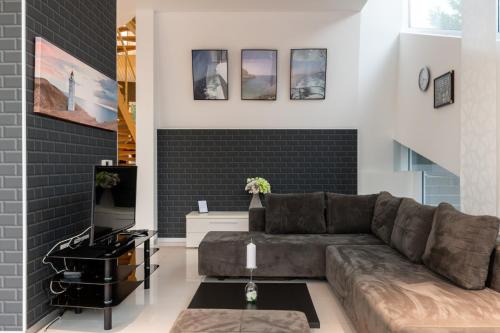 a living room with a couch and a brick wall at Vila Tina in Pula, Istrien in Medulin