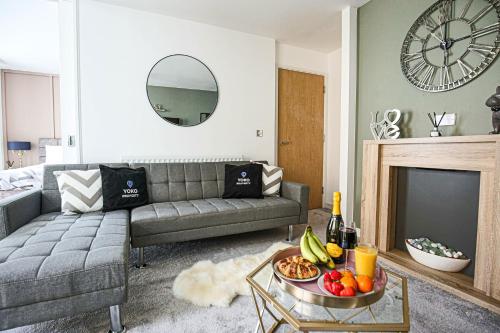 a living room with a couch and a table with fruit at Luxury Apartment - City Centre - Free Parking, Fast Wifi, Sky TV and Netflix by Yoko Property in Milton Keynes