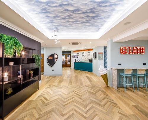 an office lobby with a skylight ceiling and wooden floors at ibis Styles Bournemouth in Bournemouth