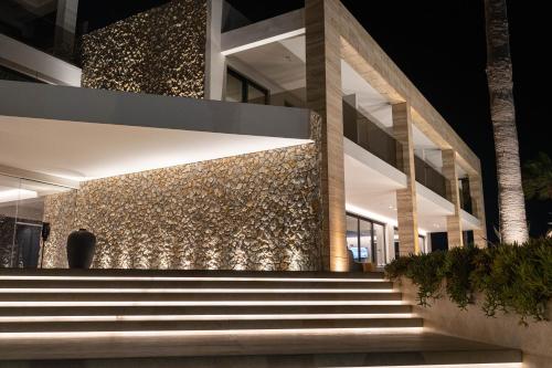 a building with stairs in front of it at night at Lango Design Hotel & Spa, Adults Only in Kos Town