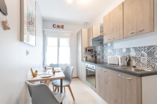 - une petite cuisine avec une petite table et des chaises dans l'établissement Le Gamay - à 5 min du château dAmboise, à Lussault-sur-Loire