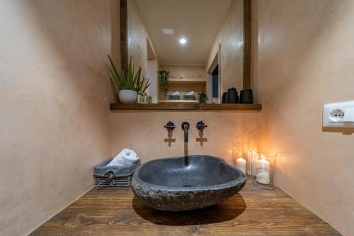 a bathroom with a large stone tub on a wooden floor at Urban Retreat in Florence