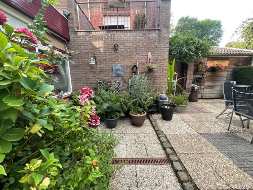 a garden with potted plants on a patio at Pension Auberge de Dael in Valkenburg