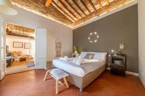 a bedroom with a large bed with a wooden ceiling at Urban Retreat in Florence