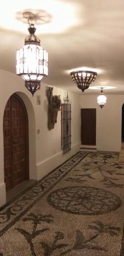 a large room with two chandeliers and a door at El Violin Experiencia Adults only in Melegis