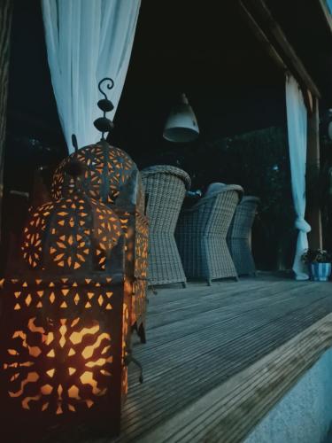 a lantern sitting on a porch with wicker chairs at El Violin Experiencia Adults only in Melegis
