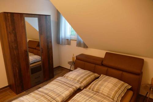 a bed in a room with a large mirror at Ferienwohnungen Brombachsee in Pleinfeld