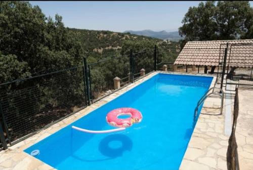 a swimming pool with a red float in the middle at Casa El Tío Patricio in Trujillos