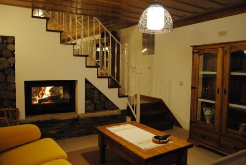 a living room with a staircase and a fireplace at Casa Do Cha in Sintra