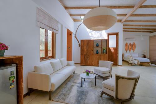 a living room with a white couch and chairs at O2 Villas Yala in Yala