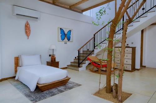 a bedroom with a bed and a tree in it at O2 Villas Yala in Yala