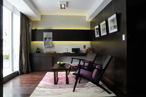 a kitchen with two chairs and a table and a counter at Mio Buenos Aires in Buenos Aires