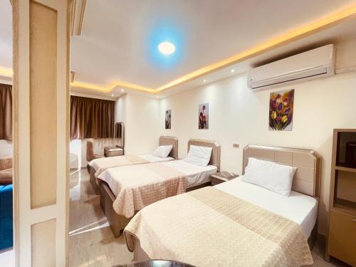 A bed or beds in a room at El mansour hotel apartmen 93