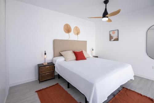 a white bedroom with a bed and a ceiling fan at Villa Casilla de Costa Private Pool Luxury La Oliva By Holidays Home in La Oliva