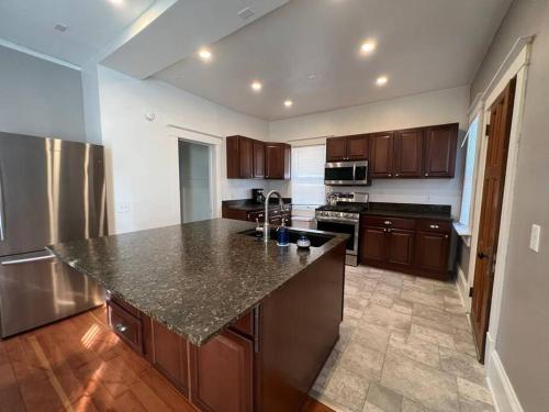 a kitchen with a granite counter top and wooden cabinets at Timelessly restored home - entirely yours to enjoy in Billings