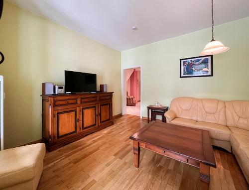 a living room with a couch and a tv at Haus Borgwardt im Ostseebad Göhren in Göhren