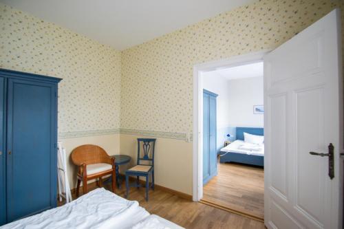 a bedroom with a bed and a room with a bed and a desk at Haus Borgwardt im Ostseebad Göhren in Göhren