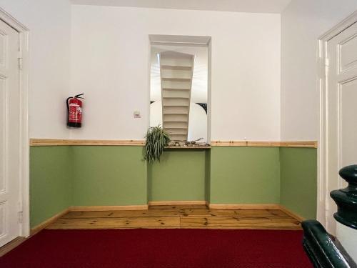 a room with green and white walls and a mirror at Haus Borgwardt im Ostseebad Göhren in Göhren