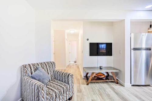 a living room with a chair and a refrigerator at New Paltz Apt - 11 Mi to Poughkeepsie! in New Paltz