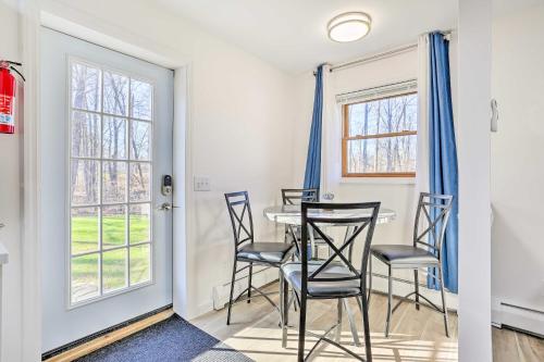 a dining room with blue curtains and a table and chairs at New Paltz Apt - 11 Mi to Poughkeepsie! in New Paltz