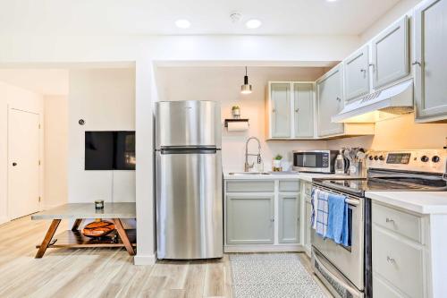 a kitchen with white cabinets and a stainless steel refrigerator at New Paltz Apt - 11 Mi to Poughkeepsie! in New Paltz