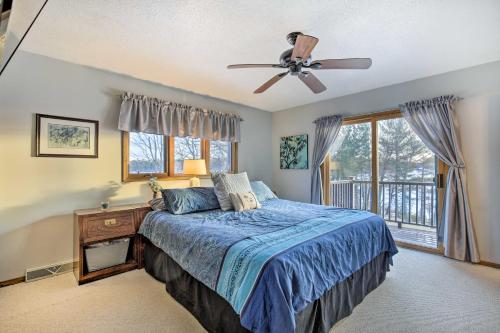 a bedroom with a bed and a ceiling fan at Lake Nokomis Escape with Dock and Beach Access in Tomahawk