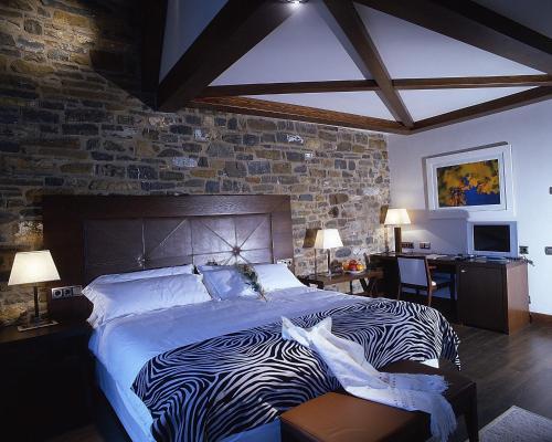 a bedroom with a zebra print bed and a desk at Los Siete Reyes in Aínsa