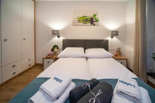 a bedroom with a bed with towels on it at Maya's Flats & Resorts 43 -Swietej Babary in Gdańsk