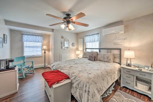 a bedroom with a bed and a ceiling fan at Spacious Michigan Home with Private Hot Tub in Gladstone