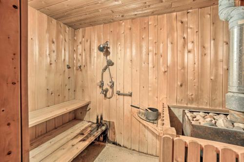 a wooden sauna with a shower and a tub at Spacious Michigan Home with Private Hot Tub in Gladstone