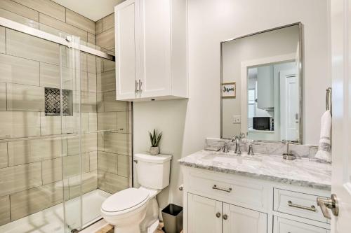a bathroom with a toilet and a shower and a sink at Fort Worth Retreat with Balcony Walk to TCU! in Fort Worth