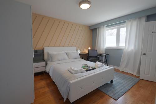 a bedroom with a large white bed and a window at Master Accord With Bath & Steps to Subway in Toronto